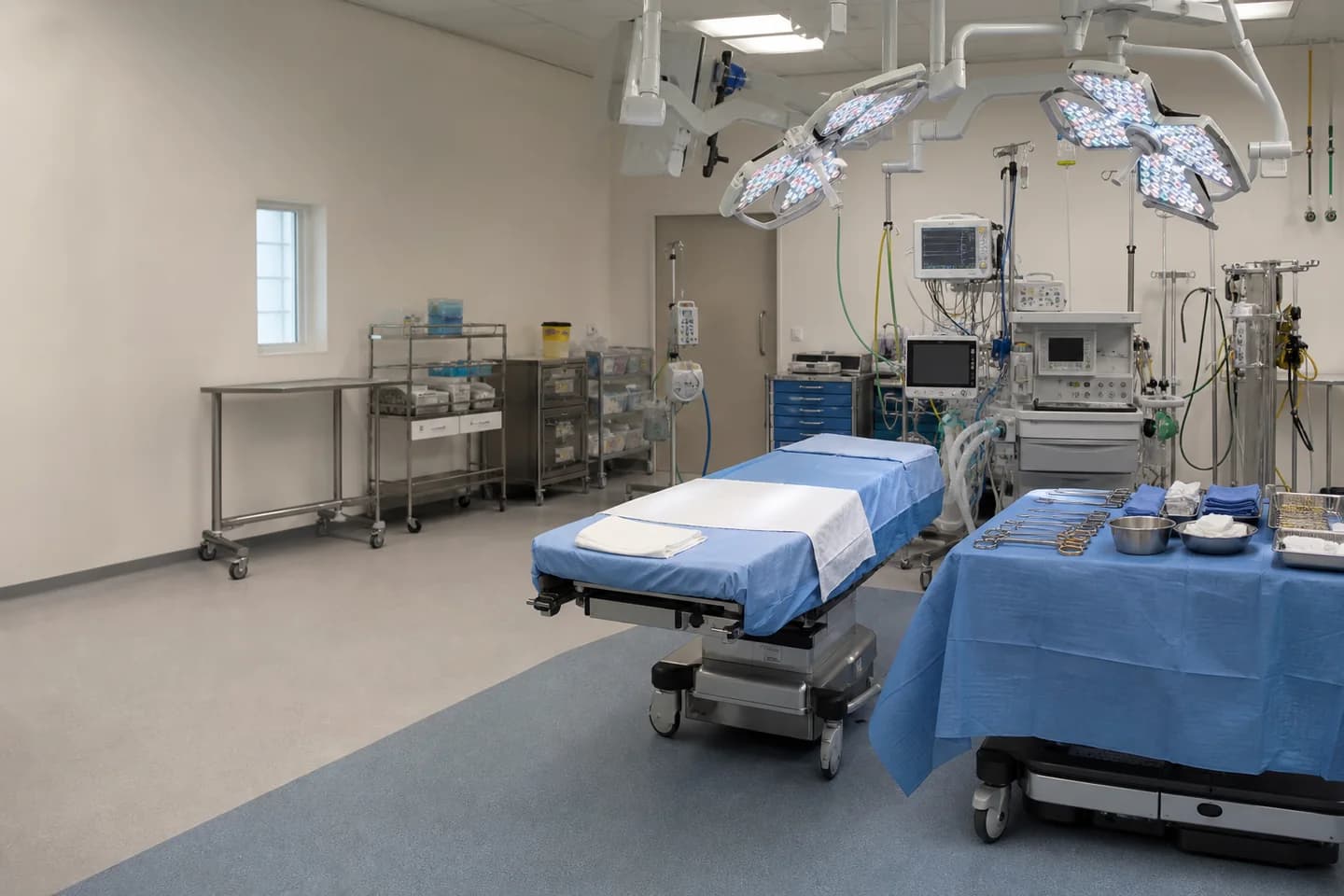 Prepared general surgery operating room with sterile drapes and anesthesia equipment