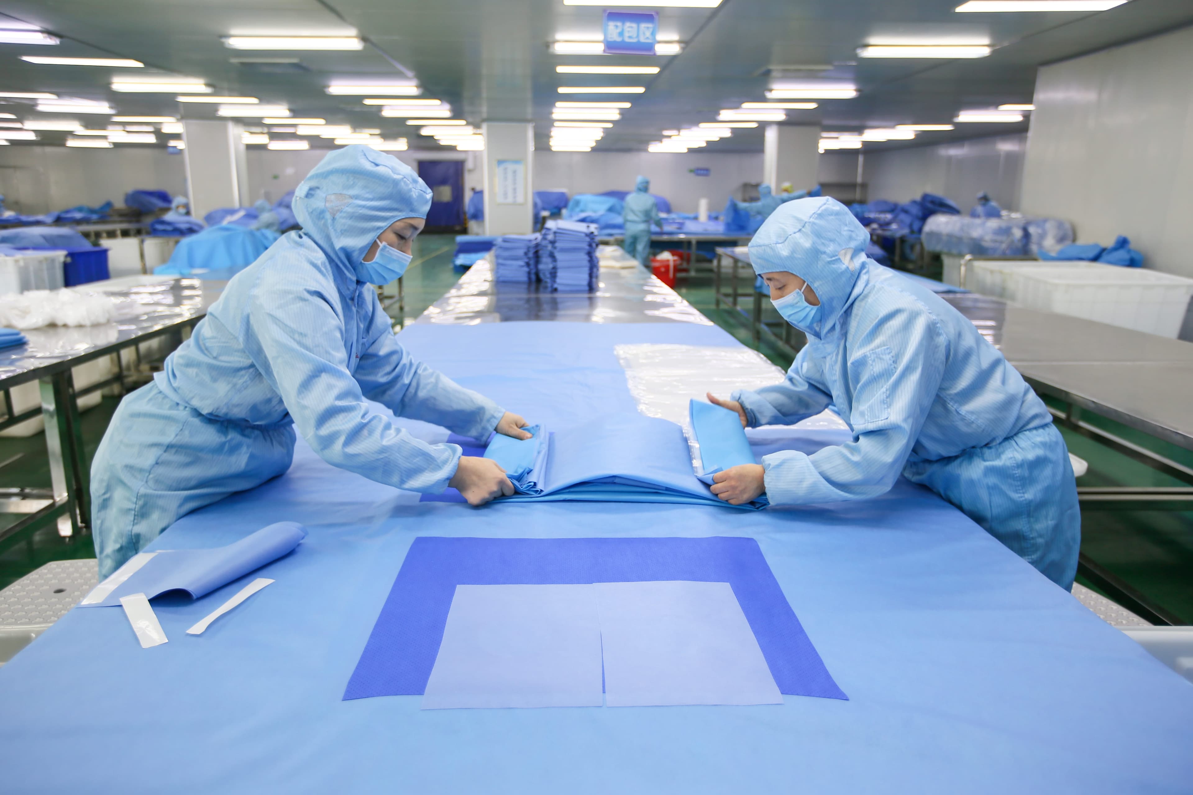 Future Tech personnel preparing surgical pack materials in the production facility